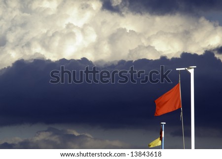 Black cloud and the red flag in he beach are promising a bad weaher. Lot of space to add text.