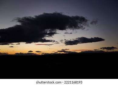 Black Clouds After Sunset With A Yellow Tint