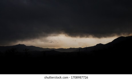 Black clouds with mountain range.