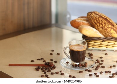 
black coffee, breads and coffee beans in the table