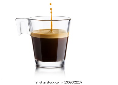 Black Coffee In Glass Cup With Jumping Drop On White Background