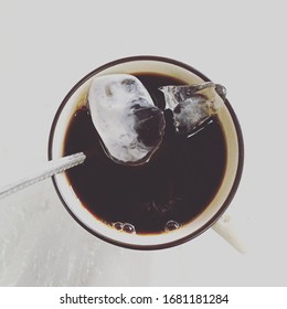 Black coffee with ice in a white backdrop