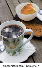 Black Coffee In A Mug With Buttermilk Rusks In The Background On A Wooden Table