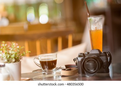 Black coffee on a  table with camera.