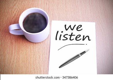 Black coffee on the table with note writing we listen - Shutterstock ID 347386406