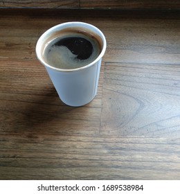 Black Coffee With Paper Cup On Wooden Table