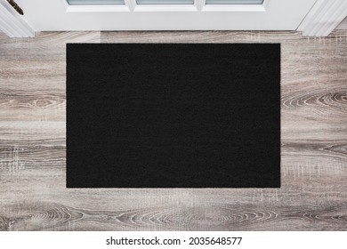 Black Coir Doormat on wooden floor in front of the door. Product mockup - Shutterstock ID 2035648577