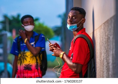 Black College Or University Student Back To Campus After Lock Down,wearing Surgical Face Mask For Protection And Holding A Smartphone,sharing Social Media Content - Concept On Student Lifestyle 