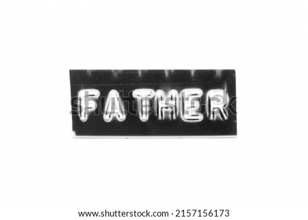 Black color banner that have embossed letter with word father on white paper background
