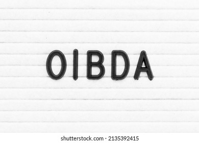 Black color letter in word OIBDA (Abbreviation of Operating Income Before Depreciation and Amortization) on white felt board background