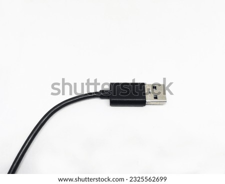 Black colored USB cable on white background with space for text, USB charging wire.