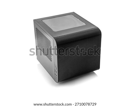 A black, compact, cube-shaped computer case with a windowed top panel and perforated mesh sides is isolated on a pure white background.
