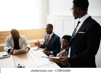 A Black Company Representative In A Black Suit Makes A Presentation To Attract Investors To A New Startup