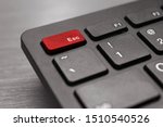 Black computer keyboard. The esc button is highlighted in red. Abort the operation. Modern technologies. Cancellation concept.