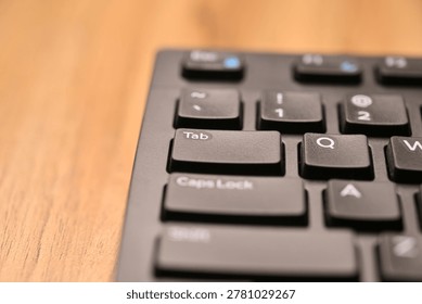 Black Computer Keyboard Macro Shot Highlighting Tab Key with Angled Top View and Soft Blurred Backgrounds