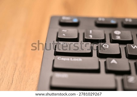 Black Computer Keyboard Macro Shot Highlighting Tab Key with Angled Top View and Soft Blurred Backgrounds
