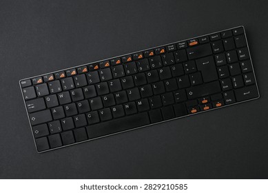 Black computer keyboard on a colored background
