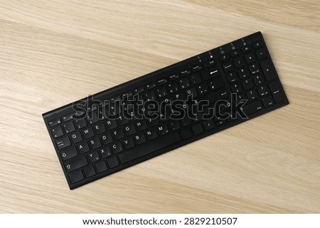 Black computer keyboard on a colored background
