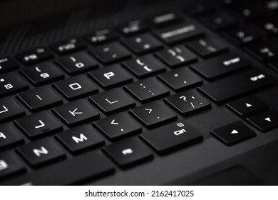 Black computer keyboard. Technological black background with white letters. Close-up, selective focus. - Shutterstock ID 2162417025