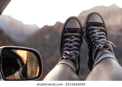 black converse (chuck taylor all star) hanging outside of a car window at Zion National Park in Utah  - Powered by Shutterstock