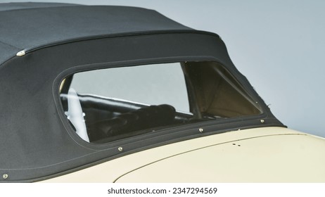 Black convertible top on a car showing the rear window