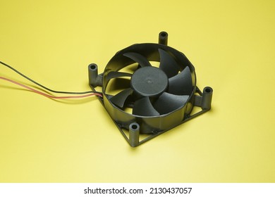 Black Cooling Fan On Yellow Background Isolated