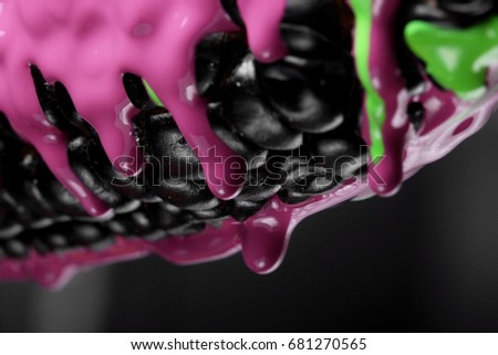 Black corn with pouring green and purple paint background, macro closeup.Texture.Abstract