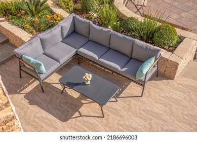 Black Corner Sofa With Gray Pillows And Metal Coffee Table In Garden Interior,shot From Above