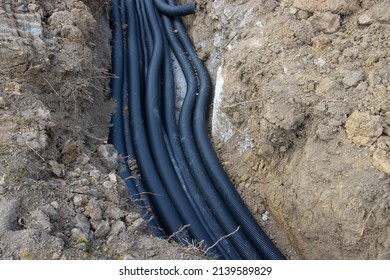 Black Corrugated Plastic Drainage Pipes Laying In A Ditch At A Construction Site