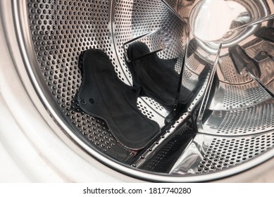 A Black Cotton Menstrual Pad On A Washing Machine