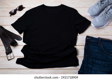 Black Men’s Cotton T-shirt Mockup With Gray Running Shoes, Dark Denim Jeans, Sunglasses And Brown Leather Belt. Design T Shirt Template, Tee Print Presentation Mock Up