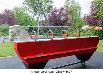 Black Country Museum,UK June 2022. Red Retro Rocking Horse Apparatus In Childrens Public Park Playground
