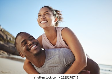 Black couple, beach and fitness with a piggy back ride for fun, energy and freedom while on vacation with happiness, love and support. Smile of man and woman on holiday by sea for a fun, summer - Powered by Shutterstock