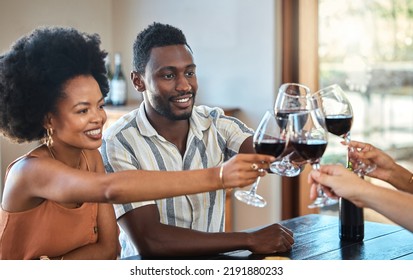 Black Couple Celebrating Their Anniversary With Friends, Toasting And Drinking Red Wine. Happy Girlfriend And Boyfriend Bonding At A Family Gathering, Together For An Engagement Or Proposal