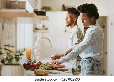 Black couple cooking in the kitchen - Powered by Shutterstock