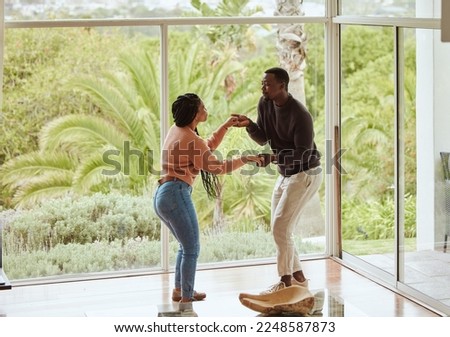 Black couple, dancing and celebration in their new home with love while excited and happy in a healthy marriage. Young man and woman partner dance to celebrate in their house or apartment for fun