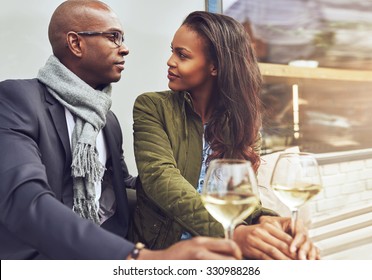 Black Couple Having A Conversation At A Cafe Outdoors In The Spring