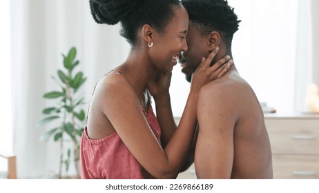 Black couple, laugh and sex intimacy kissing, bonding and enjoying foreplay in the bedroom at home. Happy African man and woman in sexual touch embracing relationship in love and happiness in bed