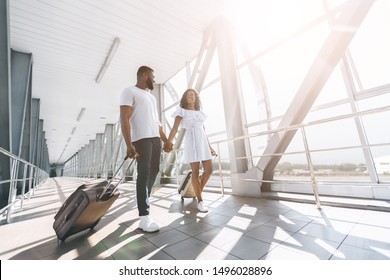 Black Couple In Love Going With Luggage At Airport Building, Enjoying Honeymoon, Free Space