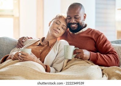 Black couple relax on sofa with coffee, blanket and smile on winter weekend morning in home. Peace, comfort and love, happy man and tired woman, cozy time on couch with drink in living room together. - Shutterstock ID 2222349539