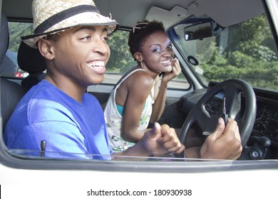 Black Couple Roadtrop In A Car Laughing