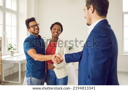 Black couple shaking hands with loan broker. Happy family meeting with realtor or real estate agency representative to establish good, successful partnership relations and confirm future