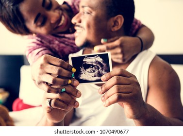 Black Couple Showing Baby Ultrasound Scan Photo