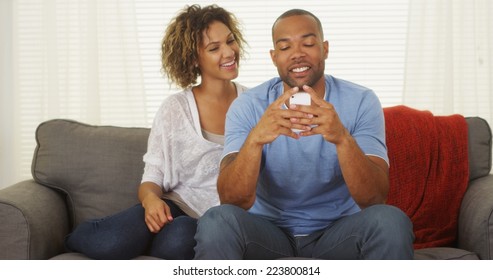 Black Couple Texting On Smartphone