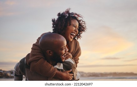 Black couple, travel and beach fun while laughing on sunset nature adventure and summer vacation or honeymoon with a piggy back ride. Comic, energy and black man and woman love on ocean holiday