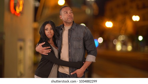 Black Couple Walking Together Along City Street Together At Night