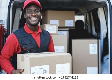 Black courier man shipping package in front of cargo truck - Focus on face