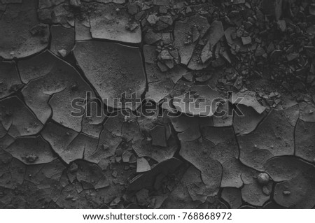 Black cracked ground. Texture photography.