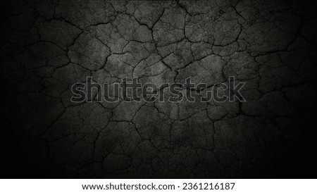 Black cracked surface of grey soil concrete wall, gloomy cement texture. Dry cracked earth. Dry land, drought, soil, dark dried and chopped gray earth, close-up erosion. Old dirty concrete cement.