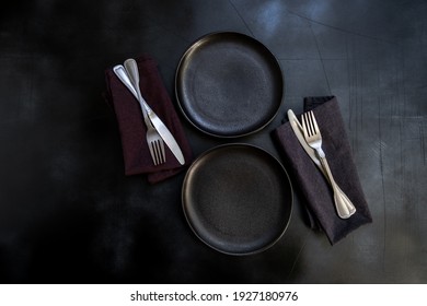 Black Craft Plate, Cutlery And Napkin On Dark Stone Table. Top View, Copy Space, Table Setting. Background For Menu, Layout, Place For Text , Recipe Background, Food Flat Lay Background